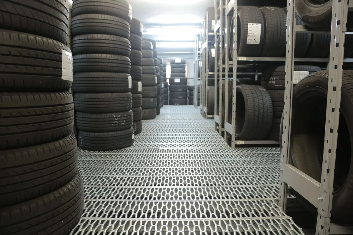 Floor-to-ceiling racks of new tyres ready for fitting