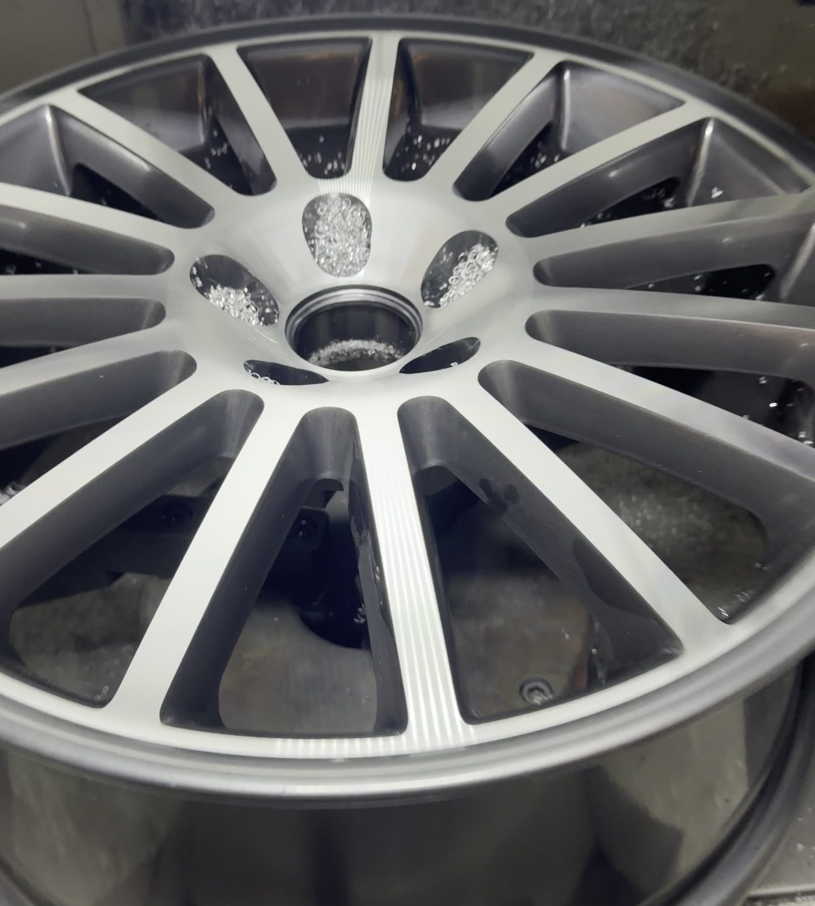 Multi spoke alloy wheel freshly diamond cut, sitting in the lathe at South Wales Alloys in Newport